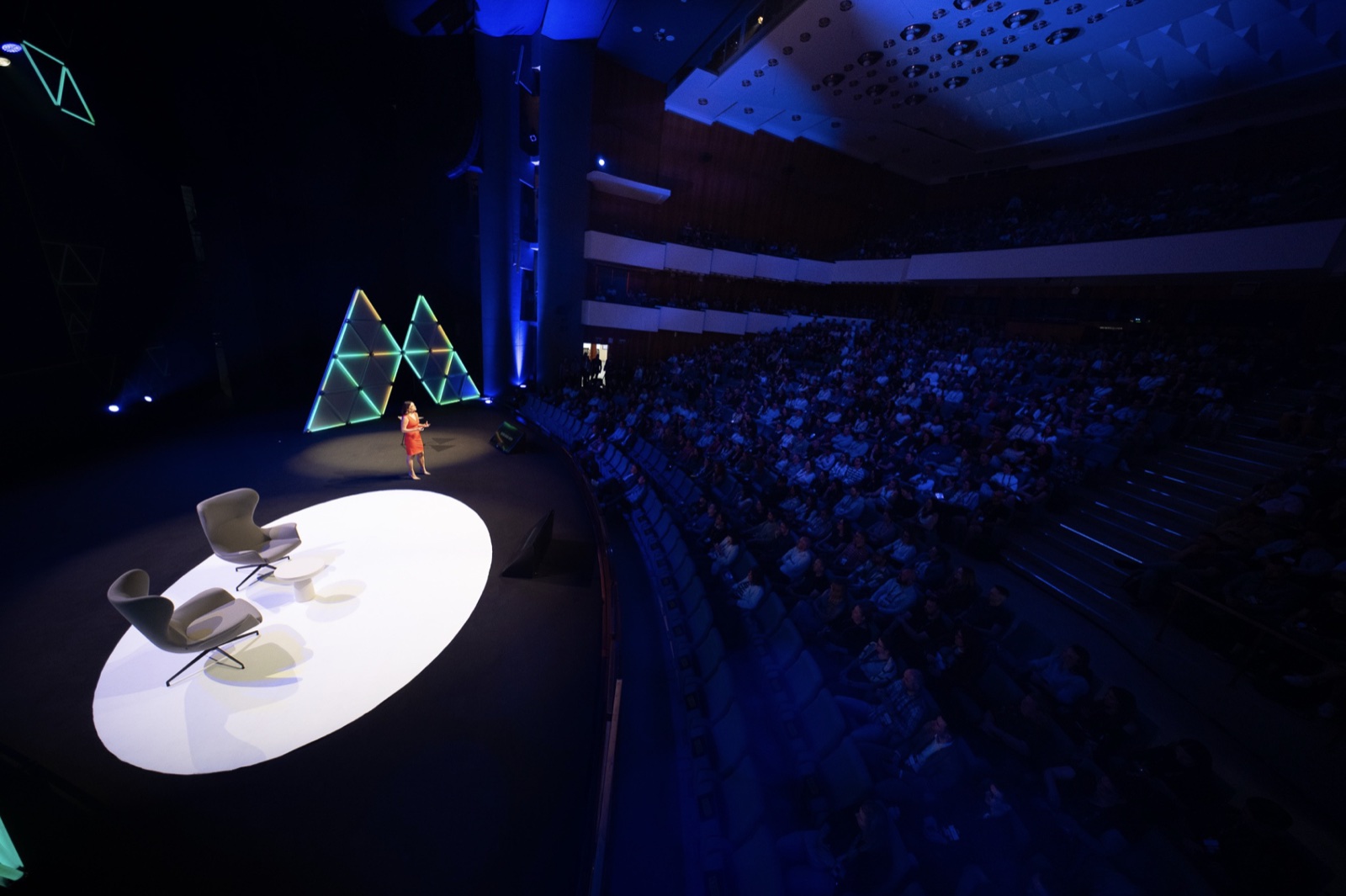 Kirsty Hulse speaking to a full auditorium
